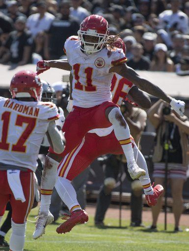 Kansas City Chiefs wide receiver Demarcus Robinson (11) celebrates a 39 yard TD pass from quarterback Patrick Mahomes (15) in the third quarter against the Oakland Raiders at Alameda Coliseum in Oakland, California on Sunday, September 15, 2019. Photo by Terry Schmitt\/