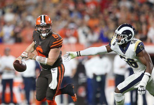 Cleveland Browns quarterback Baker Mayfield scrambles away from Los Angeles Rams Cory Littleton in the second quarter at FirstEnergy Stadium in Cleveland, Ohio on Sunday, September 22, 2019. Photo by Aaron Josefczyk\/