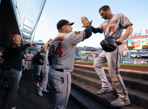 Baltimore Orioles Trey Mancini is congratulated in the dugout after scoring off a sacrifice fly hit by Jonathan Villar in the first inning against the Washington Nationals at Nationals Park in Washington, DC on August 27, 2019. Photo by Kevin Dietsch\/