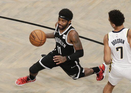 Brooklyn Nets Kyrie Irving drives to the basket past Indiana Pacers Malcolm Brogdon in the first half at Barclays Center on Wednesday, October 30, 2019 in New York City. Photo by John Angelillo\/