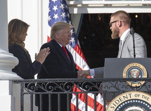 Washington Nationals pitcher Stephen Strasburg shakes hands with President Donald Trump during a ceremony for the World Series Champions on the Truman Balcony at the White House on Monday, November 4, 2019. First lady Melania Trump applauds. Photo by Pat Benic\/UPI.