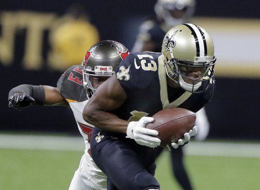 New Orleans Saints wide receiver Michael Thomas (13) picks up 34 yards before Tampa Bay Buccaneers cornerback Carlton Davis (33) can bring him down at the Louisiana Superdome in New Orleans on Sunday, October 6, 2019. Photo by AJ Sisco\/