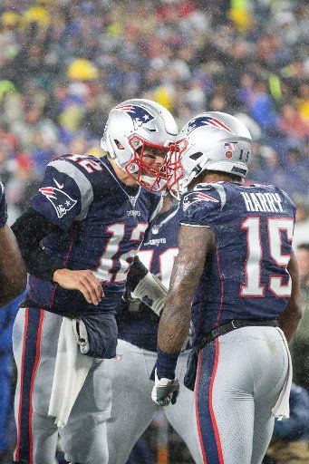 New England Patriots quarterback Tom Brady (12) celebrates with wide receiver N\
