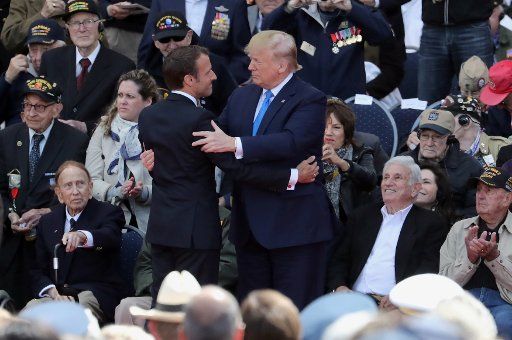 United States President Donald Trump greets French President Emmanuel Macron during the commemoration ceremony of the 75th anniversary of the D-Day landing at WWII\
