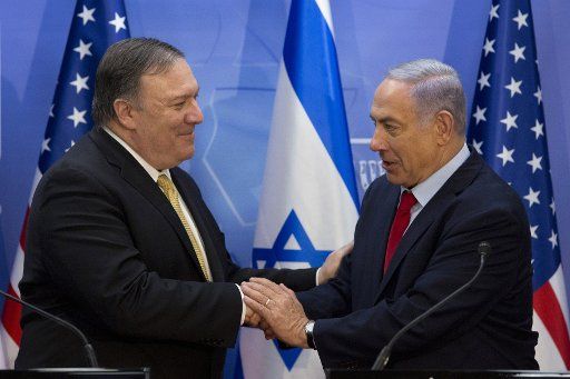 U.S. Secretary of State Mike Pompeo shakes hands with Israeli Prime Minister Benjamin Netanyahu during their meeting at the Prime Minister\