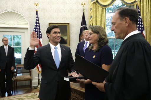 U.S. President Donald Trump looks on as Mark Esper is sworn in by Supreme Court Justice Samuel Alito as new Defense Secretary in the Oval Office of the White House in Washington on Tuesday, July 23, 2019. Photo by Yuri Gripas\/