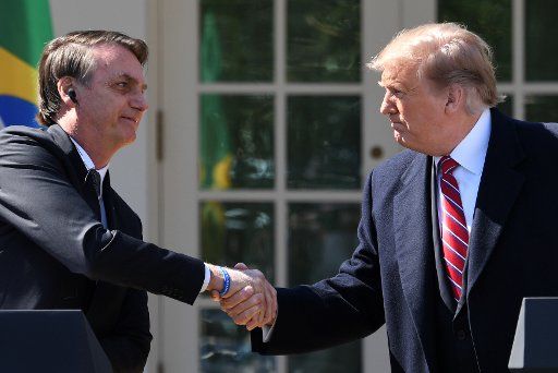 President Donald Trump shakes hands with Brazilian President Jair Bolsonaro at a joint press conference in the Rose Garden of the White House in Washington, D.C., on March 19, 2019. Photo by Pat Benic\/