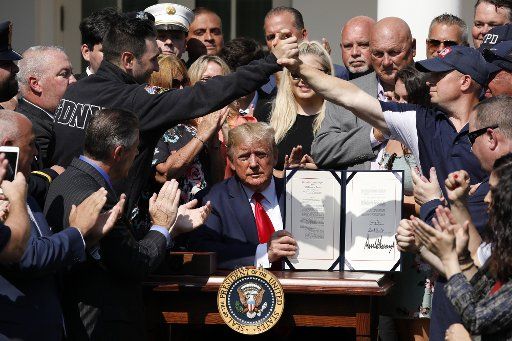 9\/11 responders react after U.S. President Donald Trump signed an act to permanently authorize the September 11th victim compensation fund, in the Rose Garden of the White House in Washington, D.C., on Monday, July 29, 2019. Photo by Yuri Gripas\/