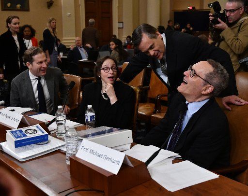 Professor Jonathan Turley (standing) talks with (L-R) Noah Feldman, Pamela S. Karlan, and Michael Gerhardt before they testify to the House Judiciary Committee, as part of the Donald Trump impeachment inquiry, on Capitol Hill, Wednesday, December 4, 2019, in Washington, D.C. Photo by Pat Benic\/