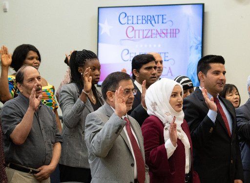 People take the oath of citizenship during a White House naturalization ceremony in the Eisenhower Executive Office Building in Washington, D.C., on Tuesday, September 17, 2019. Photo by Kevin Dietsch\/