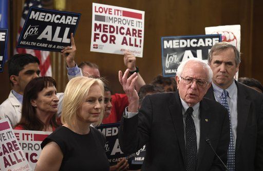 Sen. Bernie Sanders, I-VT, (C) makes remarks as he announces his intention to introduce the "Medicare for All Act of 2019," at the U.S. Capitol, on April 10, 2019, in Washington, D.C. Senators Kristen Gillibrand of New York (L) and Edward Markey of Massachusetts (R) also attended. Photo by Mike Theiler\/
