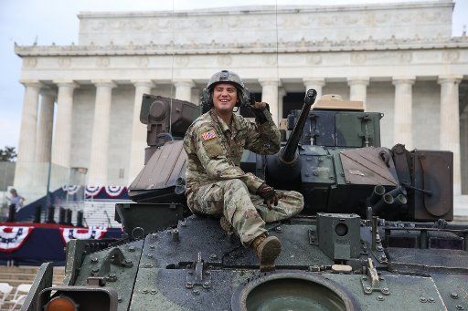 A U.S. Army soldier cleans a Bradley Fighting Vehicle at the Lincoln Memorial prior to President Donald Trump\