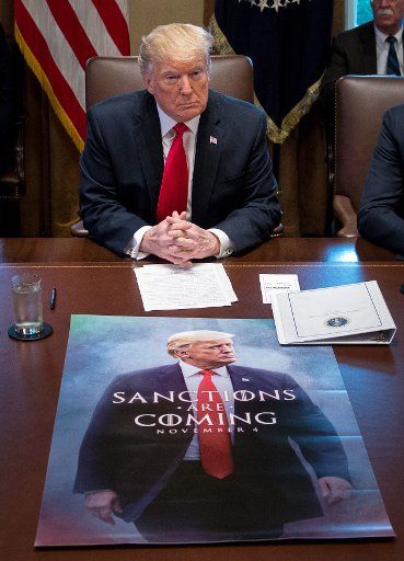 President Donald Trump speaks to the media during a cabinet meeting as a poster on sanctions is seen on the table at the White House in Washington, D.C., on January 2, 2019. Trump said he would keep the government closed for as long as possible until he gets funding for the southern border wall. Photo by Kevin Dietsch\/