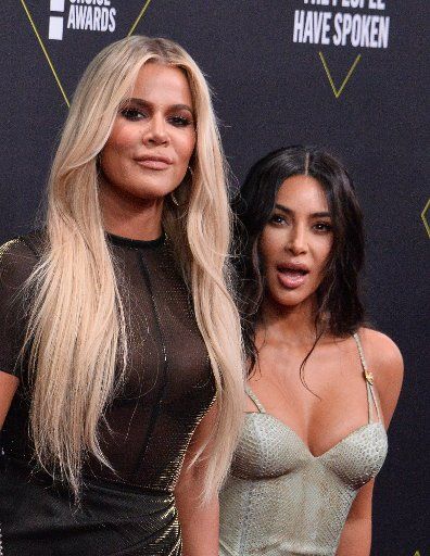 TV personalities Khloe Kardashian (L) and Kim Kardashian West arrive for the 45th annual E! People\