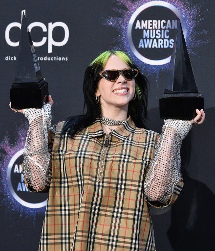 Singer Billie Eilish appears backstage with her awards for New Artist of the Year and Alternative Artist, during the 47th annual American Music Awards at the Microsoft Theater in Los Angeles on Sunday, November 24, 2019. Photo by Jim Ruymen\/