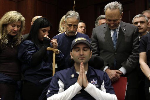 Jon Stewart (C back), former host of Comedy Central "The Daily Show," and Senate Minority Leader Chuck Schumer (D-NY) (R) attend a news conference in support of the Permanent Authorization of the September 11th Victim Compensation Fund Act on Capitol Hill in Washington on February 25, 2019. Photo by Yuri Gripas\/