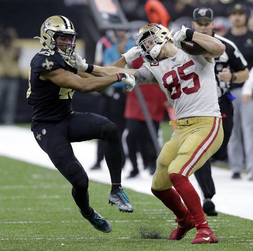 With seconds left on the clock, San Francisco 49ers tight end George Kittle (85) picks up 39 yards and a face mask penalty, putting the 49ers in position kick the winning field goal as time expires at the Mercedes-Benz Superdome in New Orleans on Sunday, December 8, 2019. Defending on the play is New Orleans Saints free safety Marcus Williams (43). Photo by AJ Sisco\/