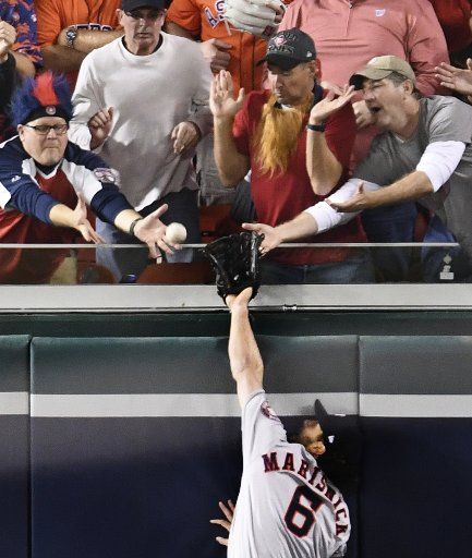 Houston Astros Jake Marisnick jumps for a home run ball hit by Washington Nationals Juan Soto in the seventh inning in Game 5 of the 2019 World Series at Nationals Park in Washington D.C. on Sunday, October 27, 2019. The best-of-seven series is tied 2-2. Photo by Pat Benic\/