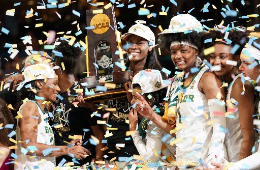 The Baylor Lady Bears celebrate with the championship trophy after defeating the Notre Dame Fighting Irish 82-81 to win the 2019 NCAA Women\