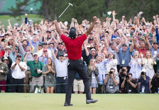 Tiger Woods celebrates on the 18th green in the final round at the 2019 Masters Tournament at Augusta National Golf Club in Augusta, Georgia, on April 14, 2019. Tiger Woods won the Masters with a score of 13 under par for his 5th Green Jacket. Photo by John Angelillo\/