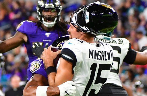 Jacksonville Jaguars quarterback Gardner Minshew (15) loses his helmet on a tackle by Baltimore Ravens inside linebacker Kenny Young (40) during the first half of an NFL preseason game at M&T Bank Stadium in Baltimore, Maryland, August 8, 2019. Photo by David Tulis\/
