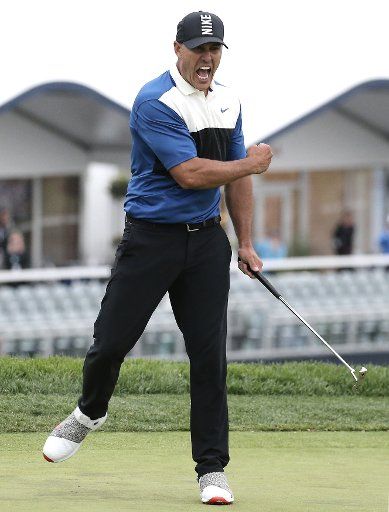 Brooks Koepka celebrates after sinking his final putt on the 18th green in the final round of the PGA Championship on the Black Course at Bethpage State Park in Farmingdale, New York, on May 19, 2019. Brooks Koepka won the 2019 PGA Championship with a score of 8 under par. Photo by Peter Foley\/