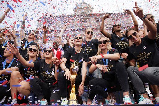 Confetti falls on Megan Rapinoe, and the players of the United States Women\