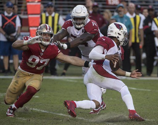 San Francisco 49ers defensive end Nick Bosa (97) is pushed away from Arizona Cardinals quarterback Kyler Murray (1) by Cardinals offensive tackle Justin Murray (71) in the fourth quarter at Levi\