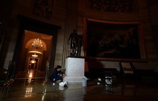 A worker cleans a statue of President George Washington in the Rotunda of the U.S. Capitol in Washington, DC, on Tuesday, November 19, 2019. Photo by Kevin Dietsch\/UPI.