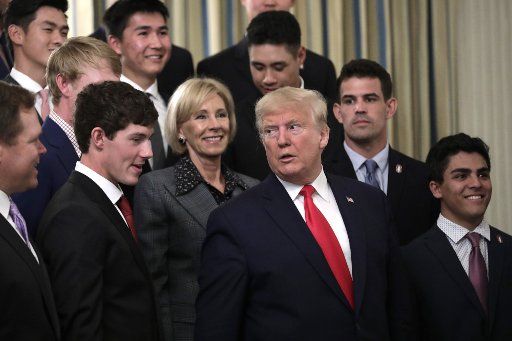 U.S. President Donald Trump with Education Secretary Betsy DeVos greets athletes from the Stanford University Men\