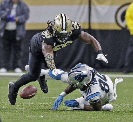 New Orleans Saints outside linebacker Demario Davis (56) knocks the ball away from Carolina Panthers tight end Ian Thomas (80) at the Mercedes-Benz Superdome in New Orleans on Sunday, November 24, 2019. Photo by AJ Sisco\/