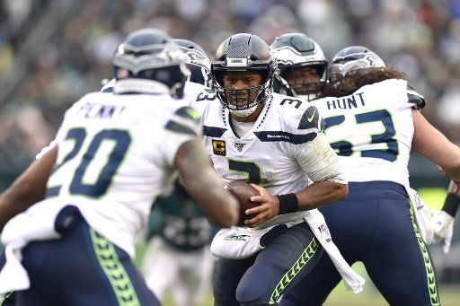 Seattle Seahawks quarterback Russell Wilson (3) hands the ball off to Rashaad Penny during the second half at Lincoln Financial Field in Philadelphia on Nov. 24, 2019. The Seahawks won 17-9. Photo by Derik Hamilton\/