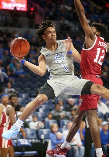 Saint Louisâ Yuri Collins passes the basketball past Massachusettsâ Carl Pierre in the first half of their game at the Chaifetz Arena in St. Louis on Sunday, January 5, 2020. Photo by Bill Greenblatt\/