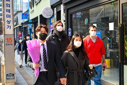 People walking in downtown Daegu, South Korea wear face masks on Friday, February 21, 2020. The majority of COVID-19 cases in the country have been traced to this southeastern city. Photo by Thomas Maresca\/