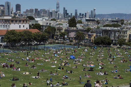 Groups hang out in pre-drawn circles in Delores Park in San Francisco on Saturday, May 23, 2020. Warm weather and a holiday weekend brought out thousands to practice their own brands of social distancing. Photo by Terry Schmitt\/