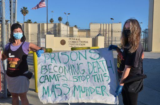 A small group of activists protest outside the Federal Correctional Institution in San Pedro, California on Saturday, May 2, 2020. The American Civil Liberties Union on Saturday filed a pair of class-action lawsuits on behalf of federal prisoners at Lompoc and Terminal Island, claiming that officials mishandled coronavirus outbreaks at the facilities that had infected a combined total of 1,775 inmates, killing 10. File Photo by Jim Ruymen\/