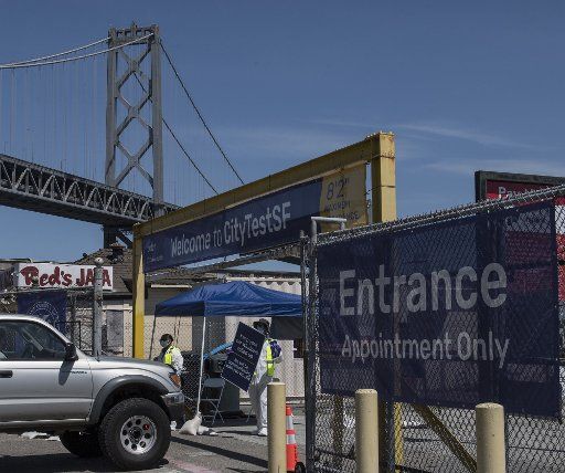 Workers advise a driver appointments are needed for coronabvirus testing at a site on the Embarcadero tn San Francisco on Thursday, April 23, 2020. San Francisco has set up drive through coronavirus testing by appointment. Photo by Terry Schmitt\/