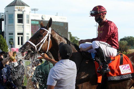 A trainer splashes water on the head of Shedaresthedevil after she won the 146th running of the Kentucky Oaks with jockey Florent Geroux at Churchill Downs Friday, September 4, 2020 in Louisville, Kentucky. Photo by John Sommers II