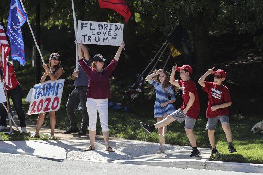 Protesters gather outside the Trump National Golf Club in Sterling, VA., on Saturday, September 5, 2020, as the motorcade with President Donald Trump departs for the White House. Photo by Oliver Contreras