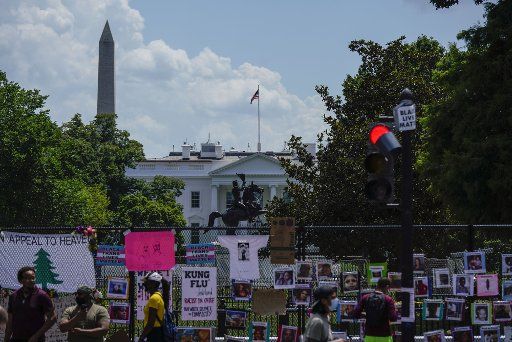 People view protest signs on a fence outside of the White House on Saturday, July 4, 2020 in Washington, DC. Signs have been posted and protests have been ongoing since the death of George Floyd in Minneapolis, MN in May 2020. Photo by Leigh Vogel