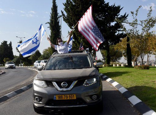 Israeli supporters of U.S. President Donald Trump wave Israeli and American flags in Jerusalem during a Trump campaign convoy, on Tuesday, October 27, 2020. Photo by Debbie Hill