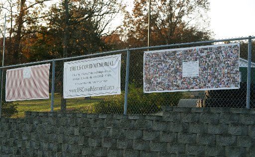 Panels of the U.S. Covid Memorial hang on a fence at the Valley Park United Methodist Church in Valley Park, Missouri on Friday, November 6, 2020. With 5,000 deaths a week from the coronavirus, Todd Hulbert started collecting names and photos in July of those that have died. The memorial, made up of photos and 22 banners of hearts, will move to Springfield, Missouri and Kansas City. Photo by Bill Greenblatt