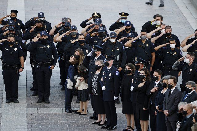 U.S. Capitol Police officers and family members of late fellow Capitol Police officer William Evans, who was killed in the line of duty on April 2, wait for the departure of the casket at the U.S. Capitol following ceremonies honoring Evans in Washington, DC on Tuesday, April 13, 2021 in Washington, DC. Pool photo by Carlos Barria