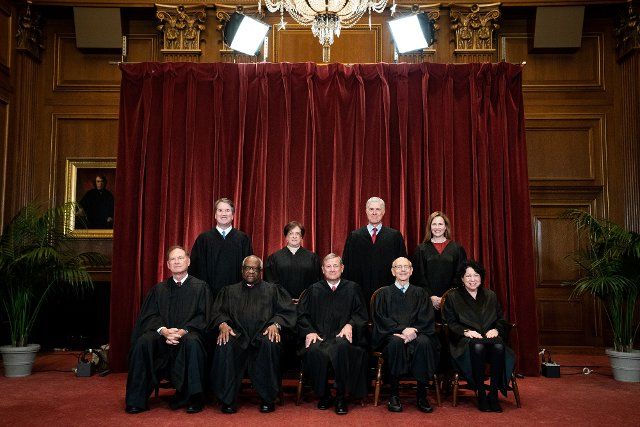 Members of the Supreme Court pose for a group photo at the Supreme Court in Washington, DC on Friday, April 23, 2021. Seated from left: Associate Justice Samuel Alito, Associate Justice Clarence Thomas, Chief Justice John Roberts, Associate Justice Stephen Breyer and Associate Justice Sonia Sotomayor, Standing from left: Associate Justice Brett Kavanaugh, Associate Justice Elena Kagan, Associate Justice Neil Gorsuch and Associate Justice Amy Coney Barrett. Pool photo by Erin Schaff