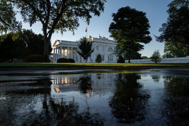 The White House is reflected in water on the driveway outside the West Wing in Washington, DC on Wednesday, June 30, 2021. Photo by Ken Cedeno