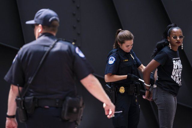 An activist is arrested during a protest in support of voting rights in the atrium of Hart Senate Office Building on Capitol Hill in Washington, DC on Thursday, July 15, 2021. Republican lawmakers around the country have introduced legislation that make it more difficult for voters to cast ballots. Photo by Sarah Silbiger