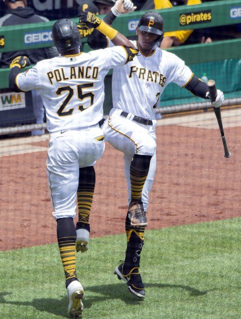 Pittsburgh Pirates right fielder Gregory Polanco (25) celebrates his homer with teammate Erik Gonzalez (2) in the fourth inning against the Chicago Cubs at PNC Park on Thursday, May 27, 2021 in Pittsburgh. Photo by Archie Carpenter