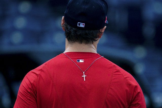 A Boston Red Sox players necklace ends up on his back after taking batting practice before the game against the Kansas City Royals at Kaufman Stadium in Kansas City, Missouri on Friday, June 18, 2021. Photo by Kyle Rivas