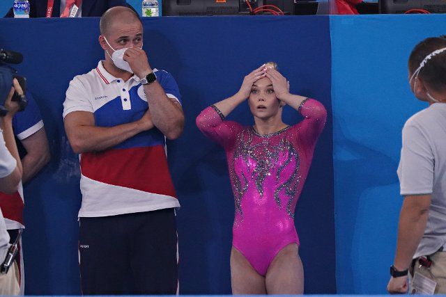 Angelina Melnikova of the Russian Olympic Committee reacts as she moves to first place during the women\