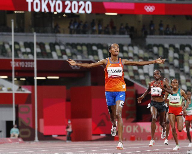 Sifan Hassan from the Netherlands celebrates as she crosses the finish ahead of Hellen Obiri of Kenya and Gudaf Tsegay of Ethiopia to win the gold medal in the Women\